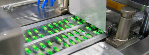 istock Green capsule medicine pill production line 1333501806