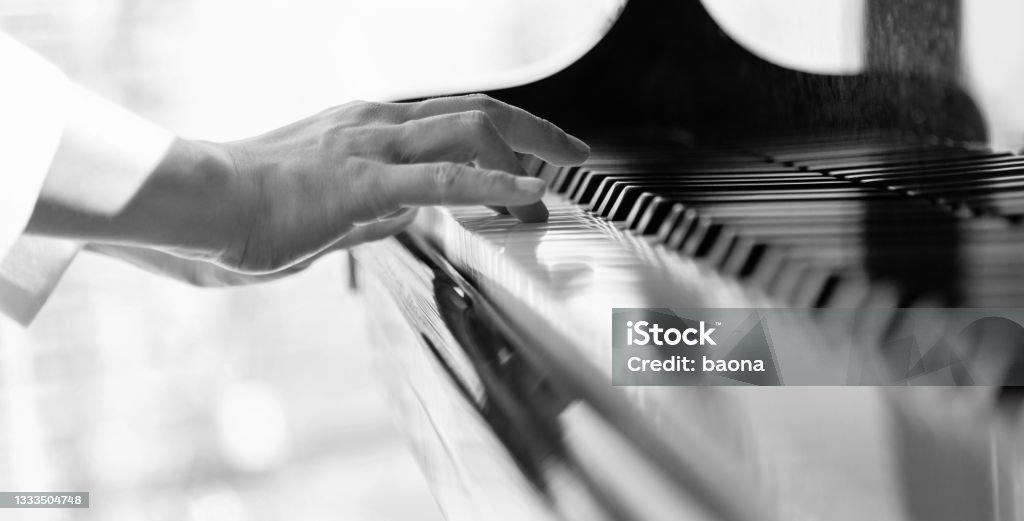 Close up of woman's hand playing the piano Close up of woman's hand playing the piano. Music Stock Photo