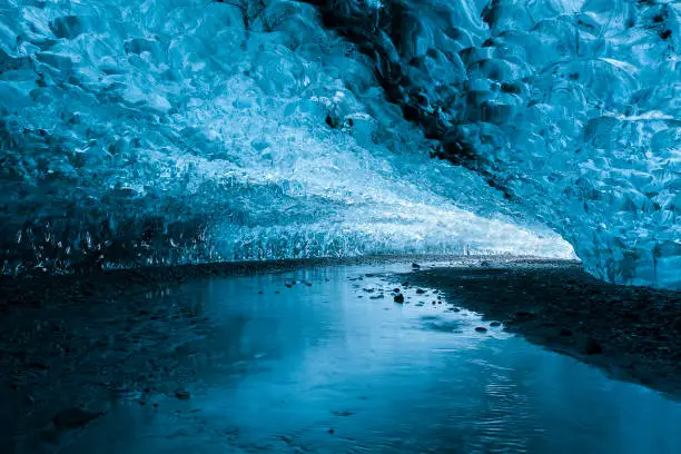 Spectacular, vibrant blue glacial ice inside an ice cave in Iceland