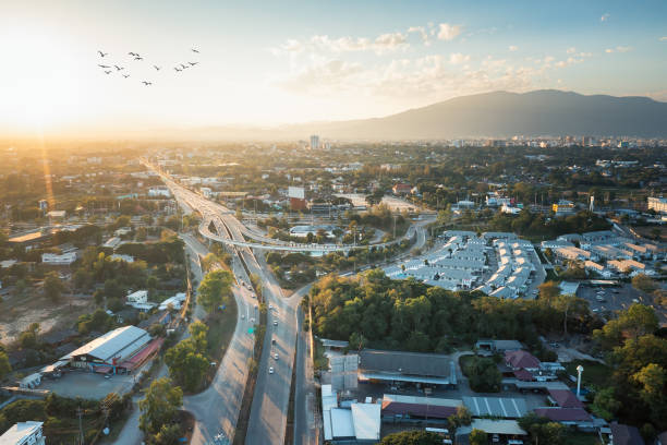 Aerial view of highway road and bridge at intersection or junction in Chiang Mai city of Thailand. Aerial view of highway road and bridge at intersection or junction. Infrastructure building in Chiang Mai city of Thailand. Many lane of street meet and cross. Busy with traffic, car, truck or vehicle chiang mai city stock pictures, royalty-free photos & images