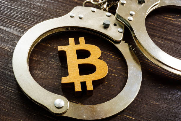 Fraud, ban and regulation of cryptocurrencies. Bitcoin sign and handcuffs. Fraud, ban and regulation of cryptocurrencies. Bitcoin sign and handcuffs. white collar crime handcuffs stock pictures, royalty-free photos & images
