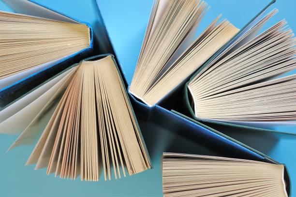 istock Books on a blue background.Reading of books.Knowledge and Learning Concept.Knowledge and education.Book pages close-up.Reading concept. 1333510445