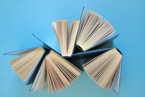 istock Books on a blue background.Reading of books.Knowledge and Learning Concept. 1333510453