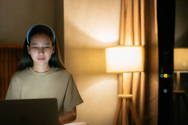 istock Woman sitting at work and masking her face at the same time at night 1333510565