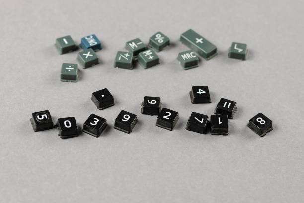 istock Broken and disassembled calculator buttons on gray background. S 1333512290