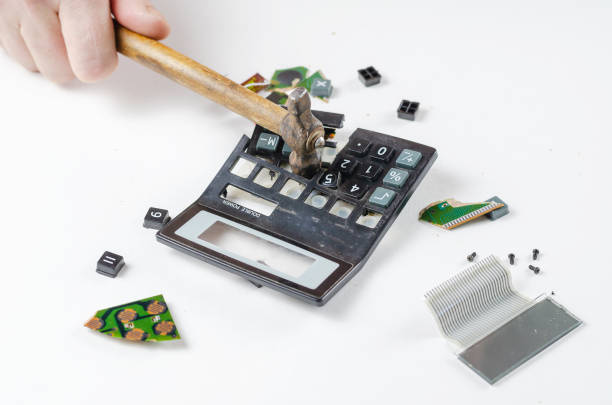 istock Nervous, irritated man smashes calculator with hammer. His hand 1333512294