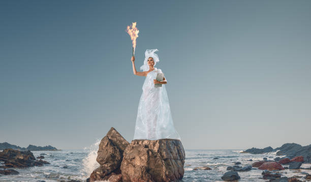 Abstract design of young woman holding torch Abstract design of young woman holding torch in her hand in front of sea goddess of ocean stock pictures, royalty-free photos & images