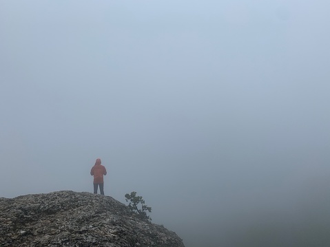 Mystic rocks and cliffs in thick fog