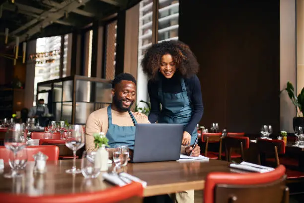 Photo of Restaurant managers working with laptop
