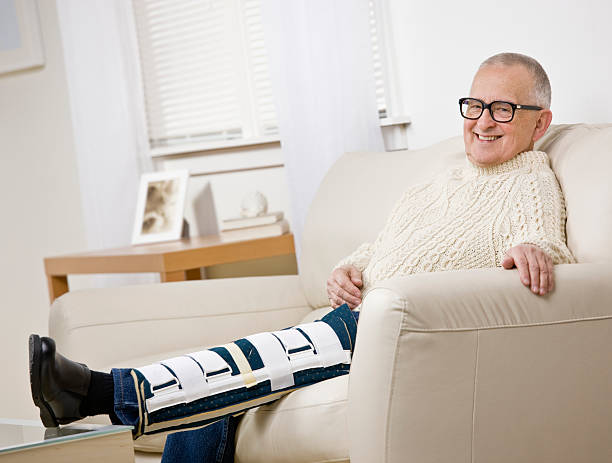 istock Disabled older man with leg brace sitting on sofa 133351317