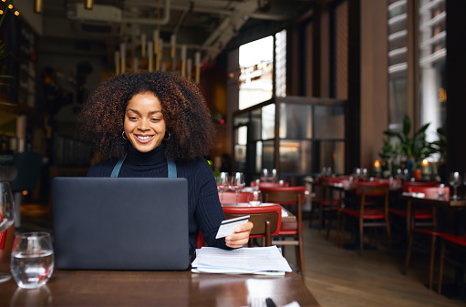 Portrait of restaurant owner using laptop