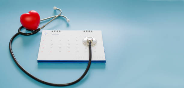 stethoscope with date on the calendar page on a blue background health care concept. - appointment reminder doctor calendar imagens e fotografias de stock