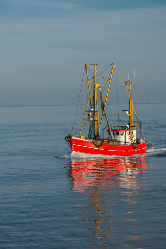 Red fishing trawler on the North Sea at the coast of Buesum, Schleswig-Holstein Wadden Sea National Park, Schleswig-Holstein, Germany