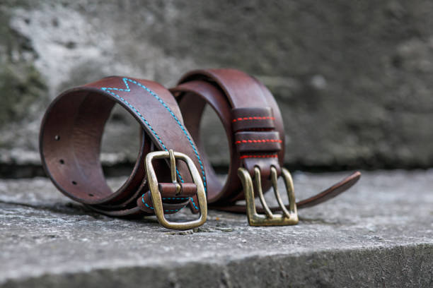 istock Two handmade brown leather belts with brass buckle. 1333517154