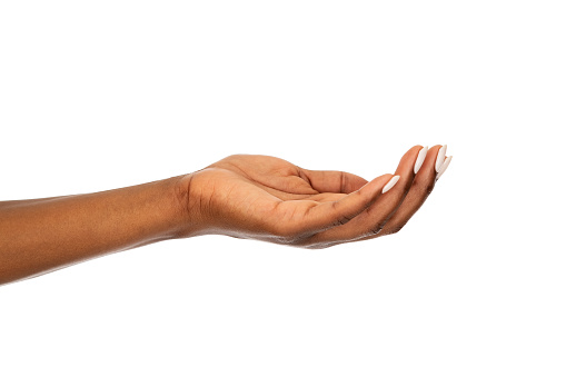 Mature african woman hand isolated against white background. Close up of black open palm hand. Isolated empty female hand showing your product or something.