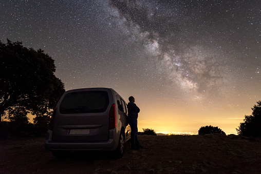 Driver takes a break in the mountain under the milky way