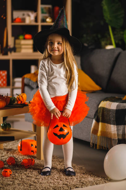 istock Cute little witch with her candy bucket ready for Halloween 1333521158