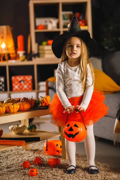 istock Little witch is ready to go trick or treating for candy on Halloween 1333521168