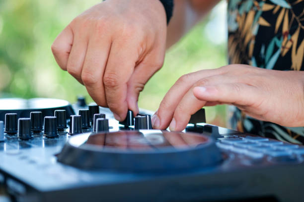 istock DJ Hands creating and regulating music on dj console mixer in beach club stage 1333521256