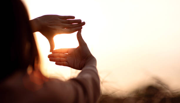 istock Future planning concept, Close up of woman hands making frame gesture with sunset. 1333522613