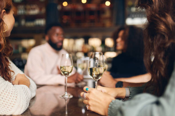 istock Friends relaxing with wine in bar 1333522861