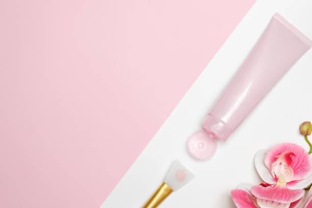 istock Cosmetic face mask on a light background with an orchid. Tube and application tool. 1333525751