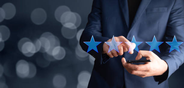 istock man holding smartphone with five star icon 1333525830