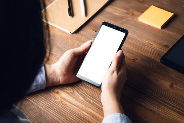 istock woman holding smart phone on working table 1333525832