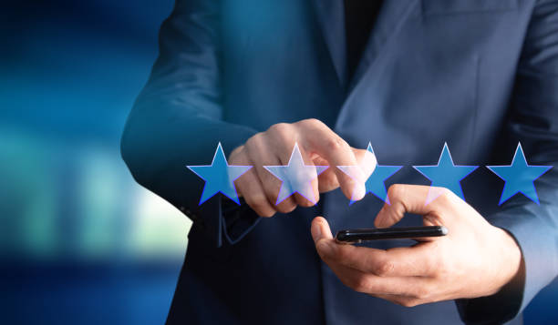 istock man holding smartphone with five star icon 1333525837