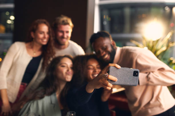 istock Friends in bar taking selfie on phone 1333526289
