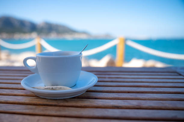 istock cup of coffee on table with  sea in background 1333526327