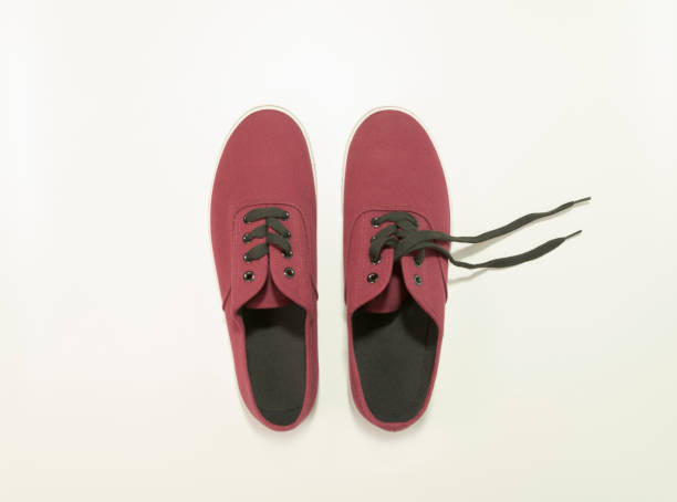 istock New sneakers. Maroon color. View from above. On white background 1333527096