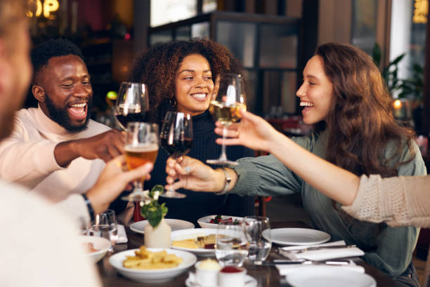 istock Friends raising glasses in restaurant 1333527311