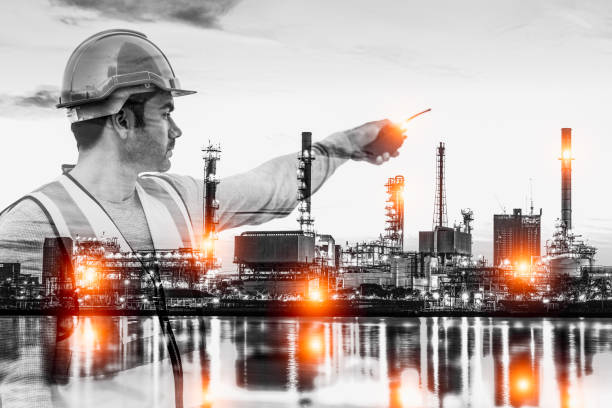 istock Black and white double exposure of smart engineer maintenance in solar power plant checking installing photovoltaic solar modules with digital tablet with Oil and gas refinery industry plant background. 1333528469