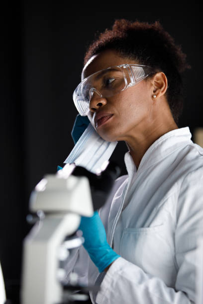 istock Female scientist putting on a protective face mask 1333529446