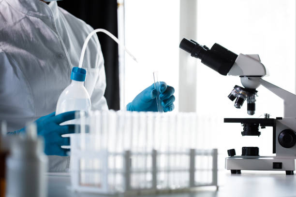 istock Female scientist pouring liquid in a test tube 1333529527