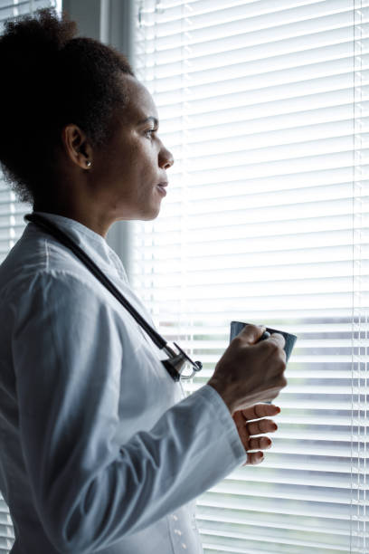 istock Doctor enjoying her coffee break and looking through the window 1333529822