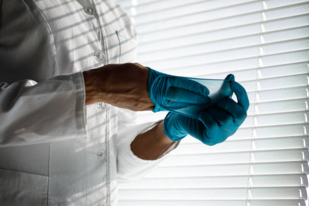istock Unrecognizable doctor taking off surgical gloves 1333529843