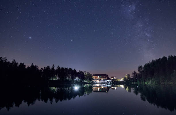 night sky with star field and the milky way over lake mummelsee in seebach, germany. - forest black forest sky night imagens e fotografias de stock