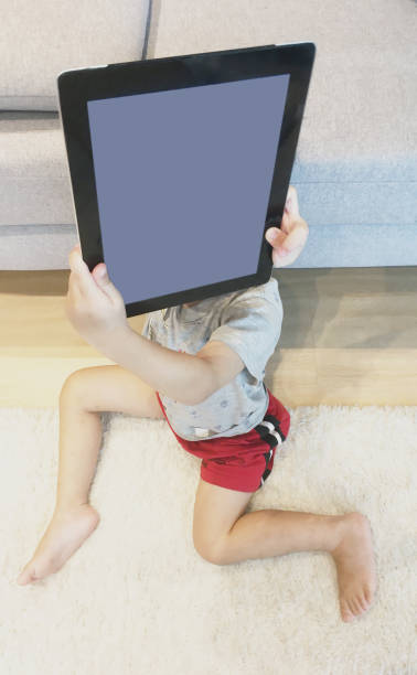 istock Asian Chinese boy playing with tablet at home 1333532648