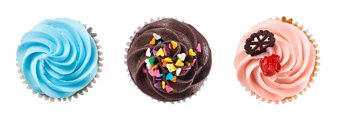 Top view of chocolate and vanila cream cupcakes isolated on white with clipping path