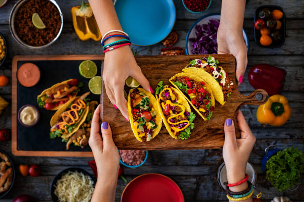 Many types of tacos on the table. Mexican street food concept. taco stock pictures, royalty-free photos & images