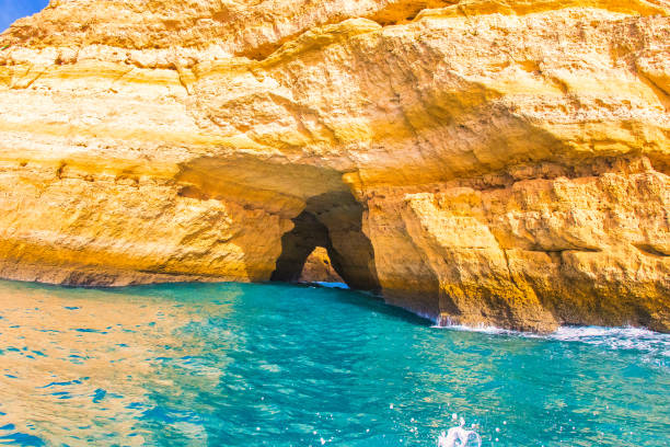 a boat ride shows the rocky coast of the algarve Albufeira, Portugal - January 20, 2016 : the entrance to a cave, seen on a boat ride shows the rocky coast. benagil photos stock pictures, royalty-free photos & images