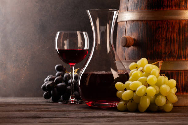 istock Decanter,red wine, grapes and old wooden barrel 1333539271