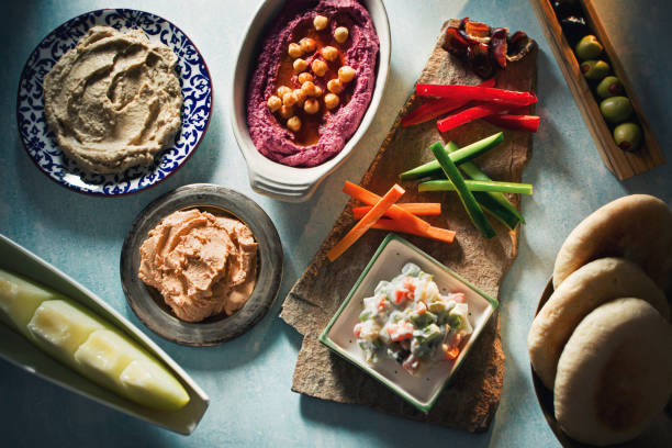 Traditional Middle Eastern Style Mezze Platter with Beet Hummus, Baba Ganoush and Vegetables