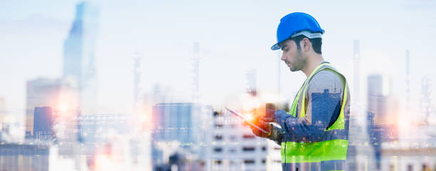 istock Panoramic double exposure of smart engineer maintenance in solar power plant checking installing photovoltaic solar modules with digital tablet with Oil and gas refinery industry plant background. 1333542458