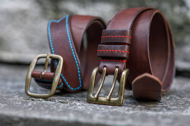 istock Two handmade brown leather belts with brass buckle. 1333543642