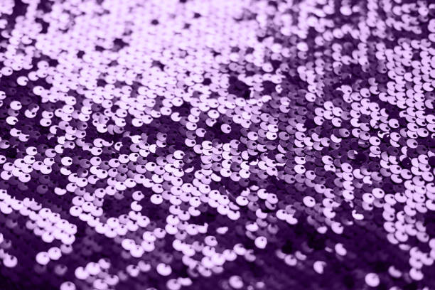 istock Sequin fabric texture. Shiny silver sparkling background. Clothing piece of glitter metallic for a glamorous party, celebration. Close-up. Toned image. 1333546155