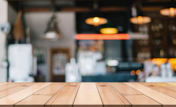 istock Empty wooden table top with lights bokeh on blur restaurant background. 1333547358
