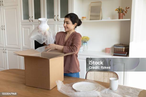 Happy Indian Woman Unpack Box With Tableware Order Stock Photo - Download Image Now - Moving House, Box - Container, Relocation